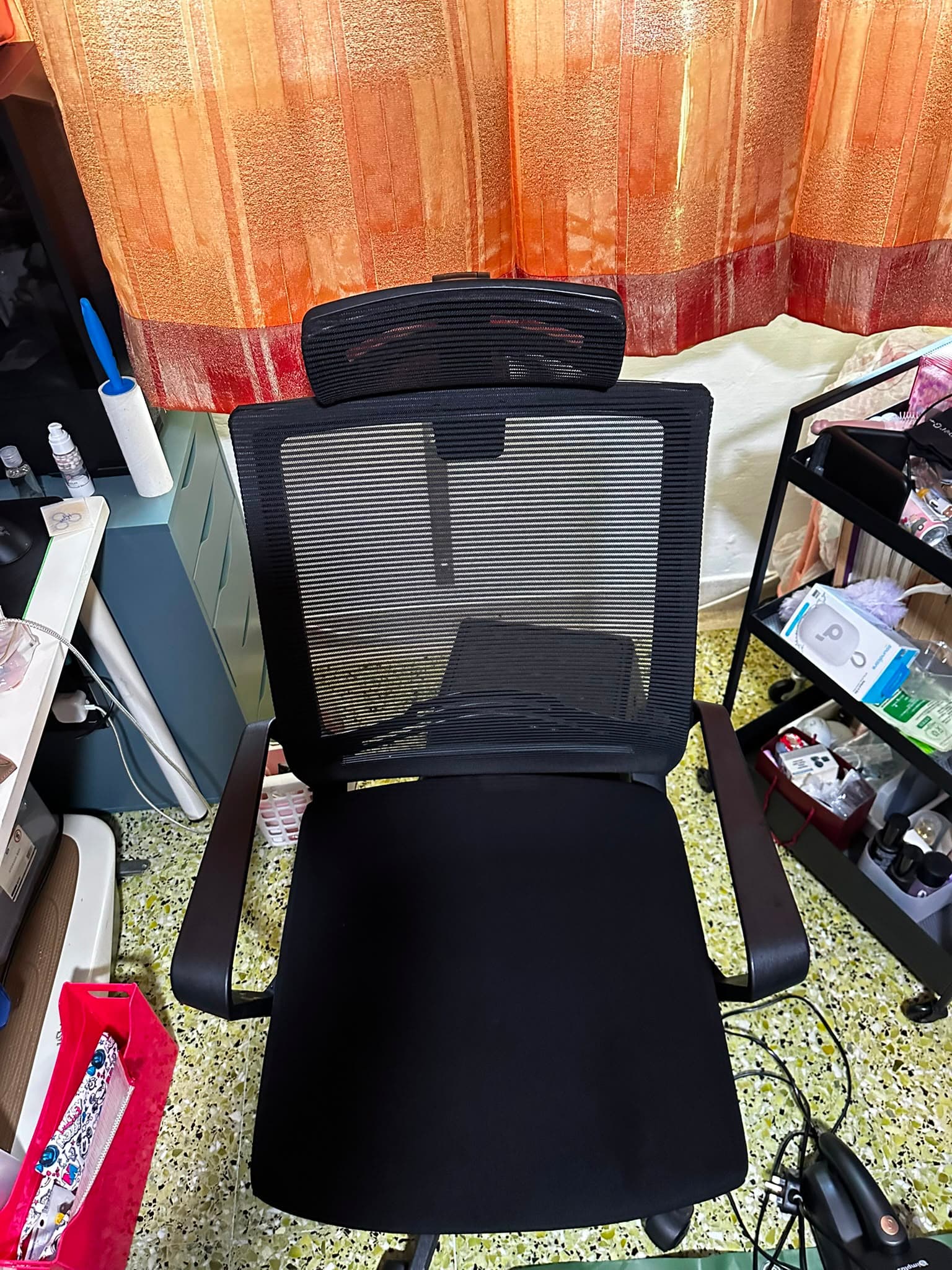 The same black mesh office chair after cleaning, with a clean seat