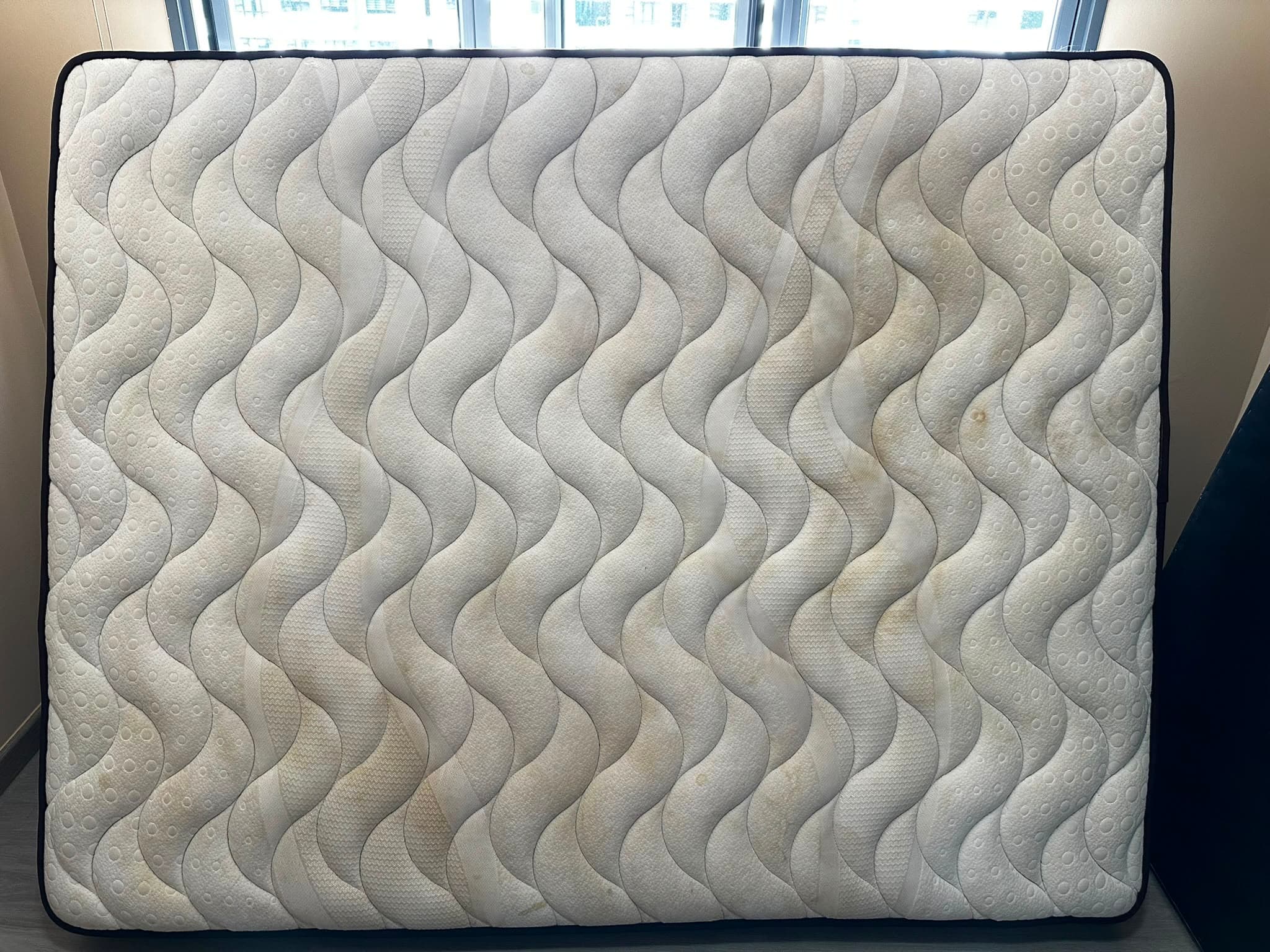 The same mattress after cleaning, with stains visibly reduced