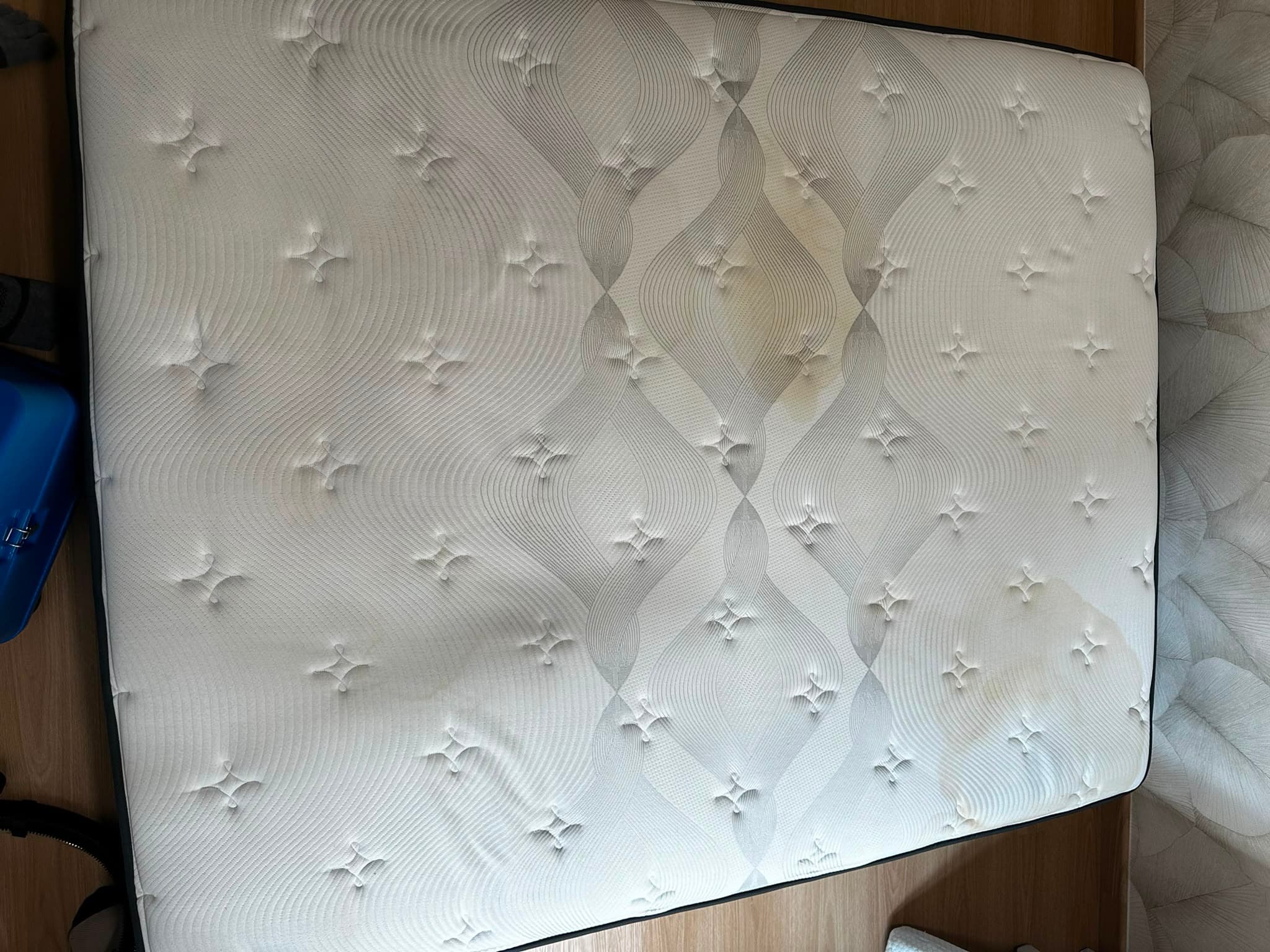 Mattress before cleaning, with stains and discolouration